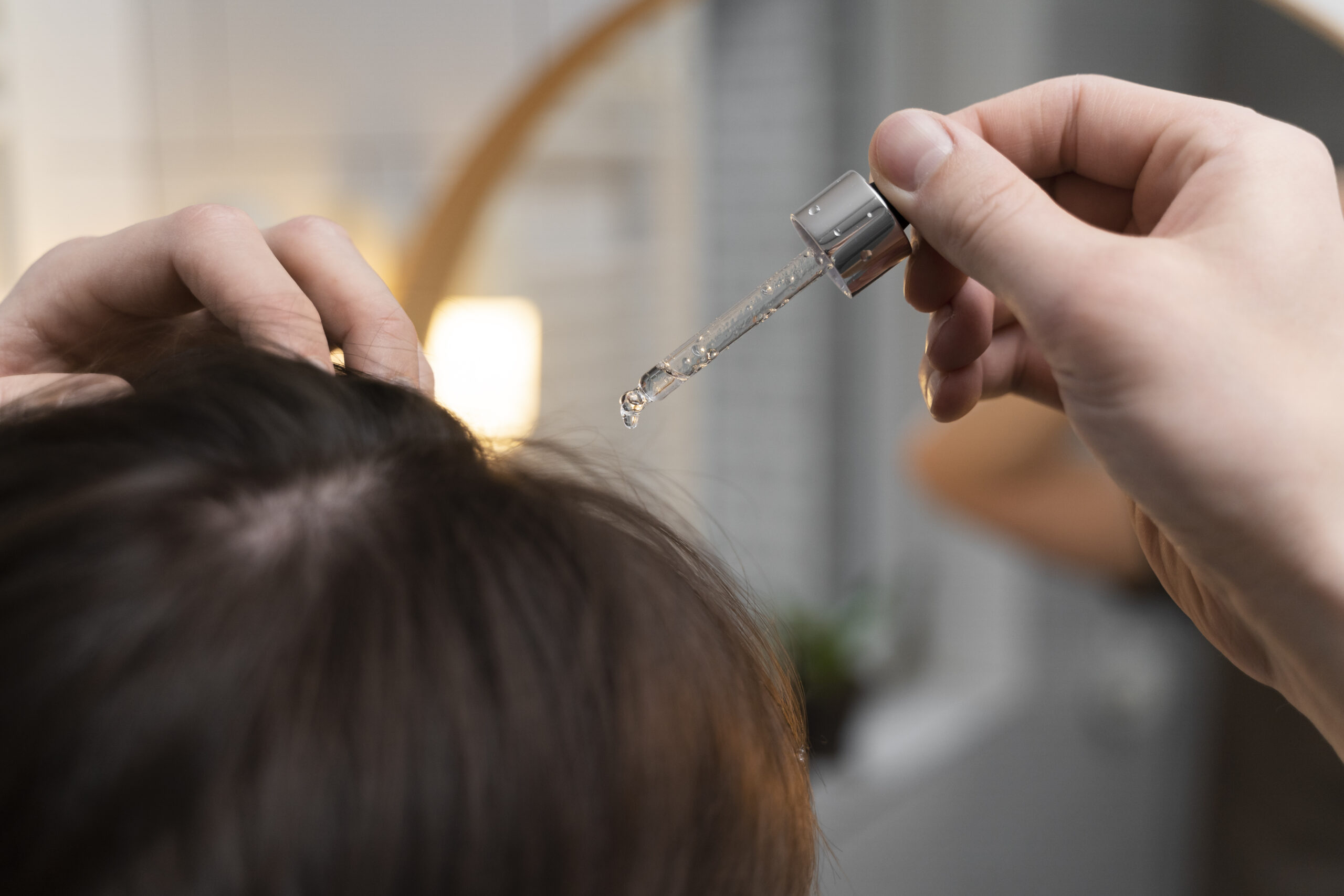 Best 5 Hair Growth Serums in 2025: Growth & Volume 1 young man applying anti dandruff product scaled